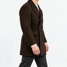 Herringbone double breasted coat with wide lapels in dark brown — male model side view