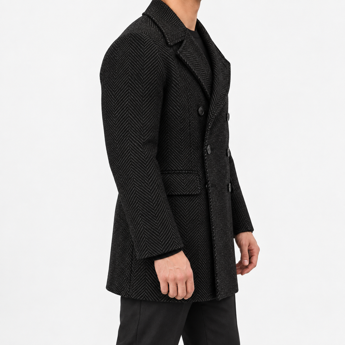 Herringbone double breasted coat with wide lapels in black — male model side view