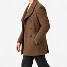 Herringbone double breasted coat with wide lapels in brown — male model side view