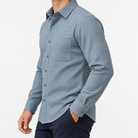 Brushed cotton flannel shirt with a chest pocket in blue gray microcheck on a male model side view