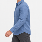 Brushed cotton flannel shirt with a chest pocket in blue microcheck on a male model side view