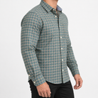 Pure cotton oxford shirt with a chest pocket in sage green check on a male model side view