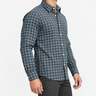 Pure cotton oxford shirt with a chest pocket in navy fine check on a male model side view