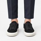 Canvas lace up sneakers with contrast soles in black, front view on a model