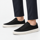 Canvas lace up sneakers with contrast soles in black, side view on a model
