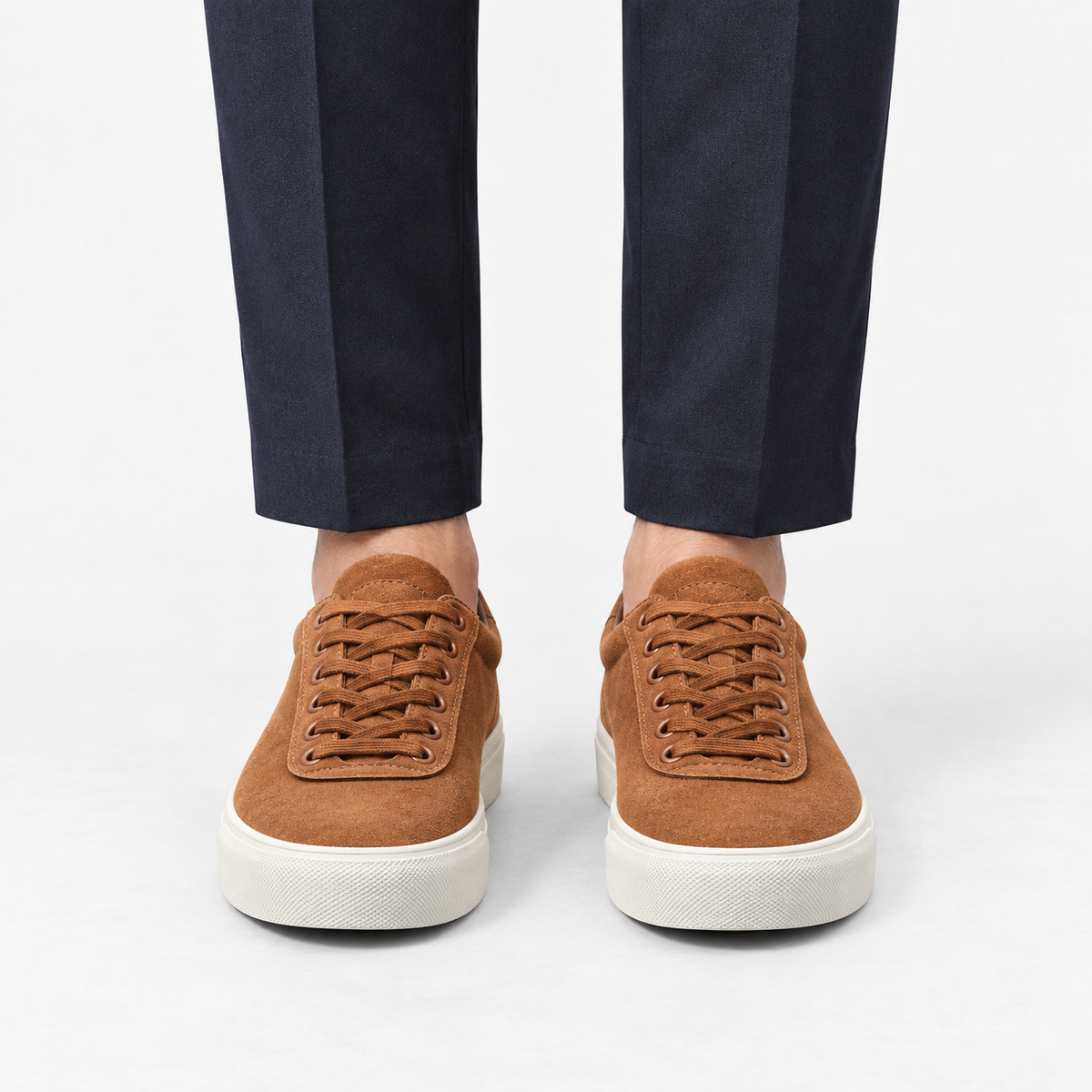 Canvas lace up sneakers with contrast soles in brown, front view on a model