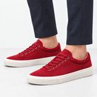 Canvas lace up sneakers with contrast soles in red, side view on a model