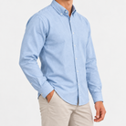 Cotton oxford button down shirt in light blue, side view on a model