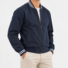 Cotton varsity jacket with striped trim in navy, side view on a model