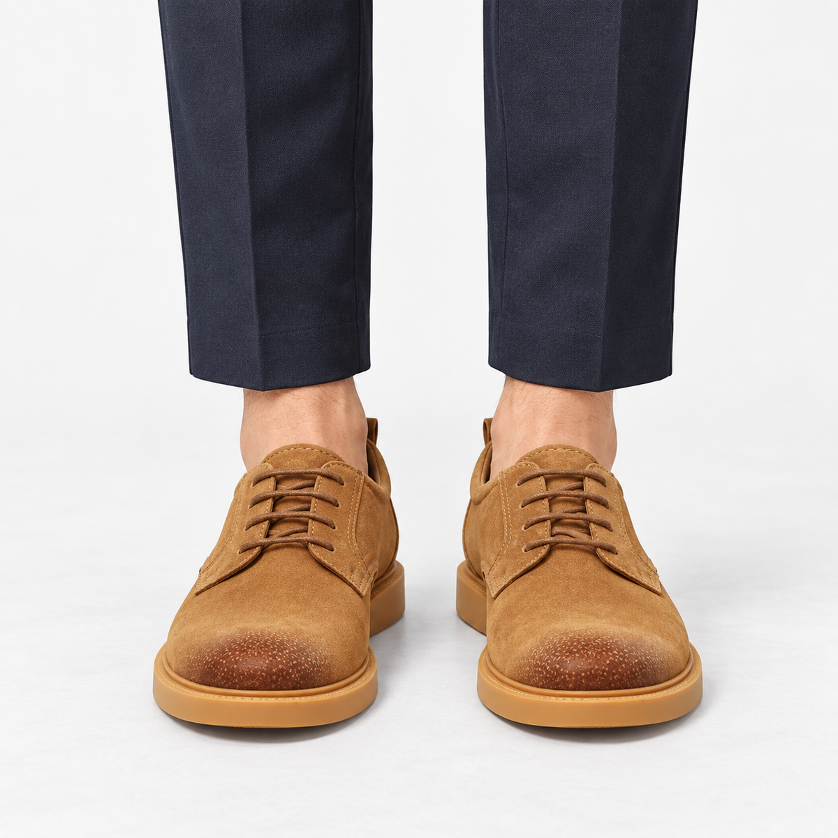 Distressed derby shoes with flexible soles in tan, front view on a model