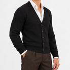 Fine knit cashmere v neck cardigan in black, side view on a model