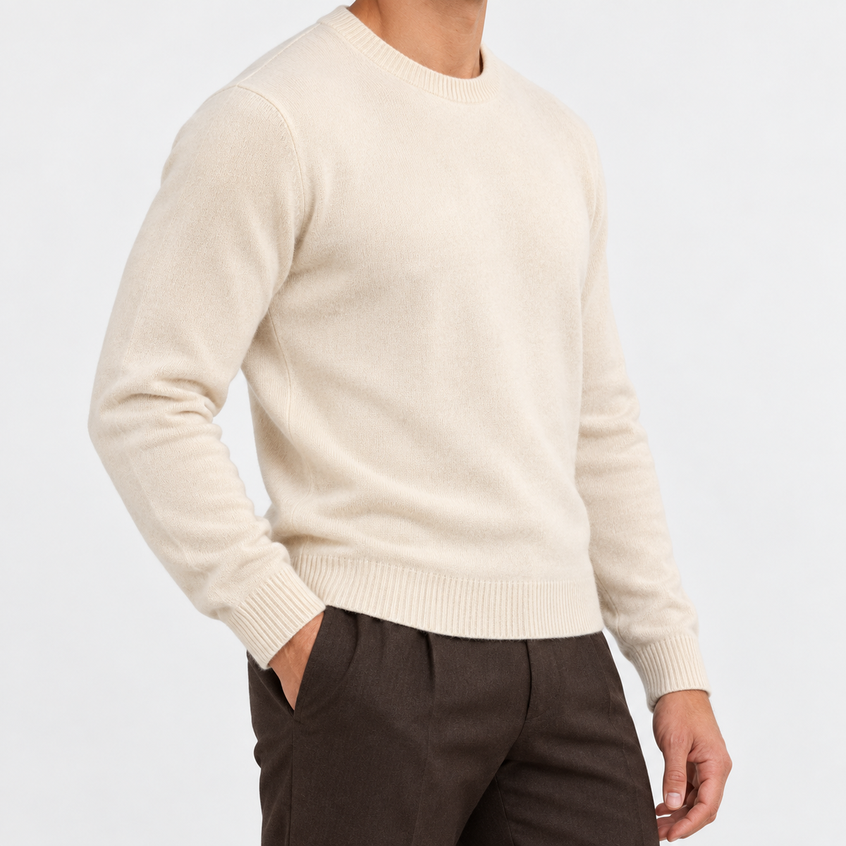 Fine knit wool crew neck sweater in cream, side view on a model