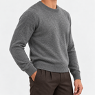 Fine knit wool crew neck sweater in dark gray, side view on a model