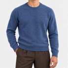 Fine knit wool crew neck sweater in denim blue, front view on a model