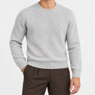 Fine knit wool crew neck sweater in light gray, front view on a model