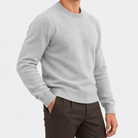 Fine knit wool crew neck sweater in light gray, side view on a model