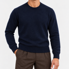 Fine knit wool crew neck sweater in navy, front view on a model