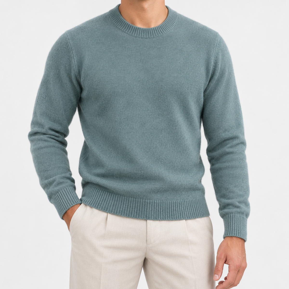 Fine knit wool crew neck sweater in stone green, front view on a model