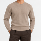 Fine knit wool crew neck sweater in taupe, front view on a model