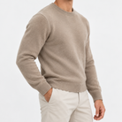 Fine knit wool crew neck sweater in taupe, side view on a model