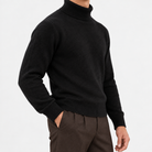 Fine knit wool turtleneck sweater in black, side view on a model