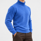 Fine knit wool turtleneck sweater in blue, side view on a model