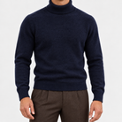 Fine knit wool turtleneck sweater in navy, front view on a model