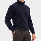 Fine knit wool turtleneck sweater in navy, side view on a model