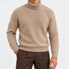 Fine knit wool turtleneck sweater in taupe, front view on a model