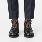 Leather cap toe lace up boots in black, front view on a model