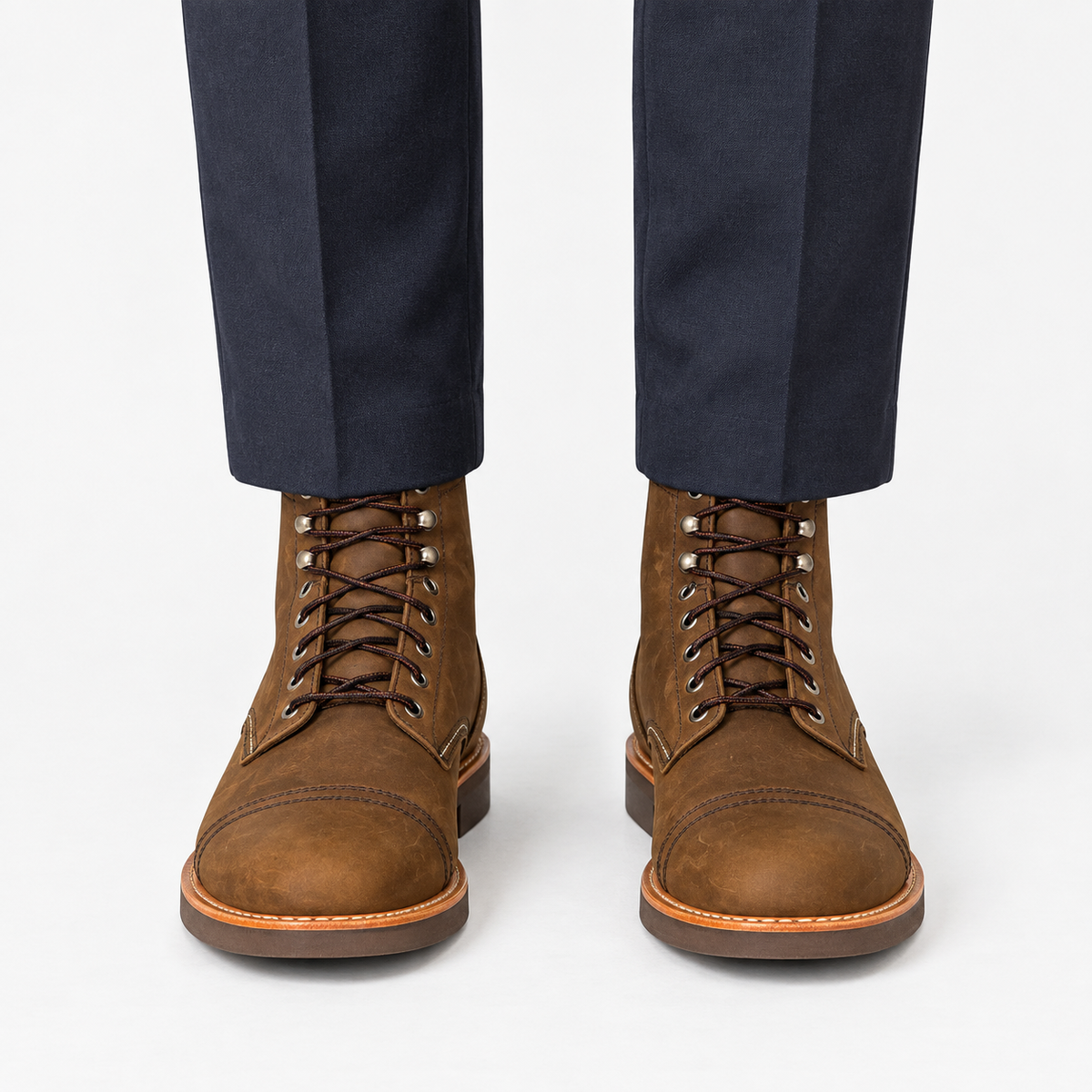 Leather cap toe lace up boots in brown, front view on a model