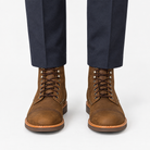Leather cap toe lace up boots in brown, front view on a model