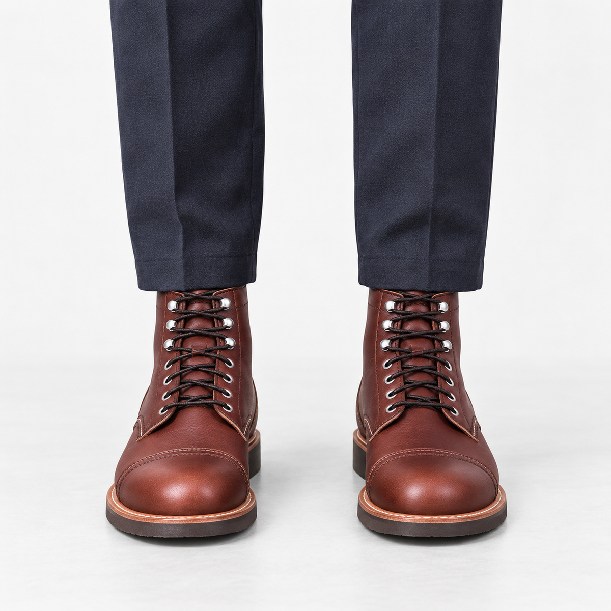 Leather cap toe lace up boots in burgundy, front view on a model