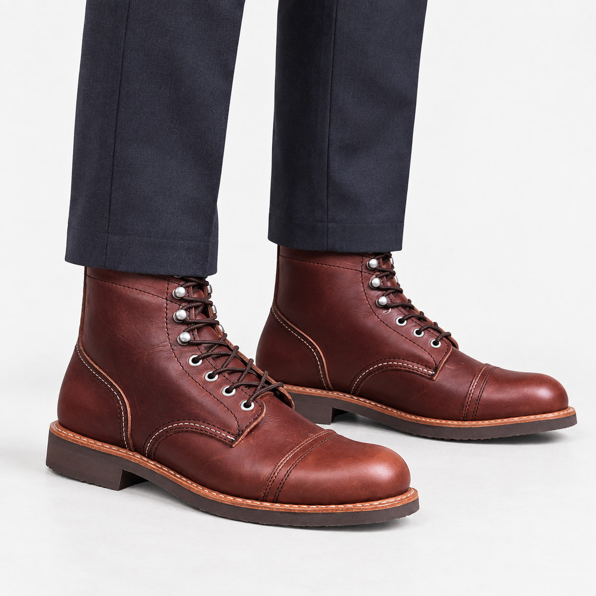 Leather cap toe lace up boots in burgundy, side view on a model