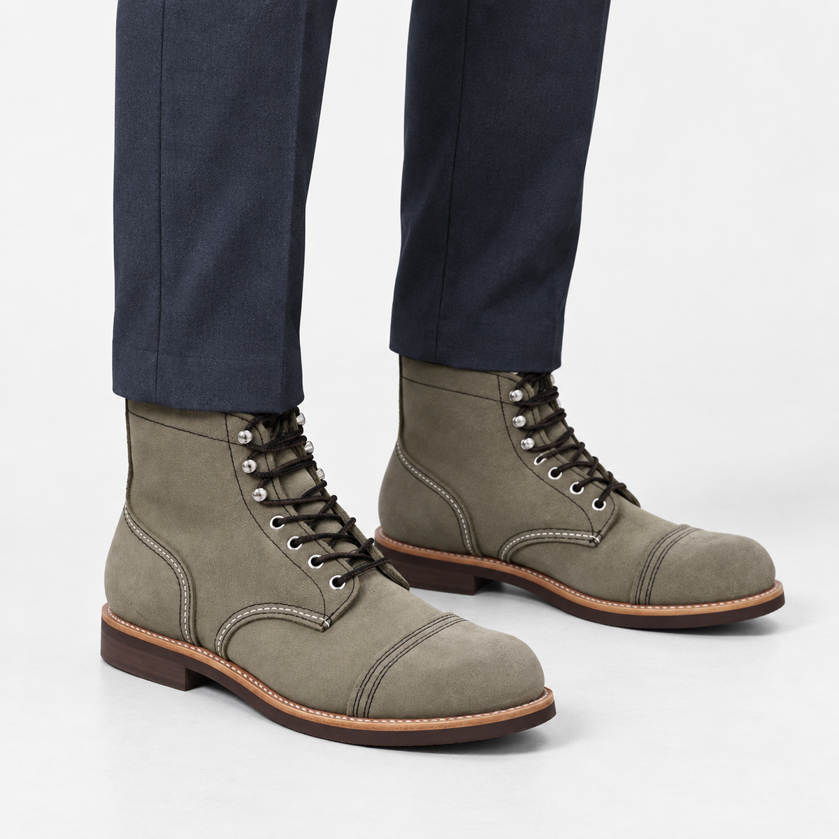 Leather cap toe lace up boots in gray suede, side view on a model