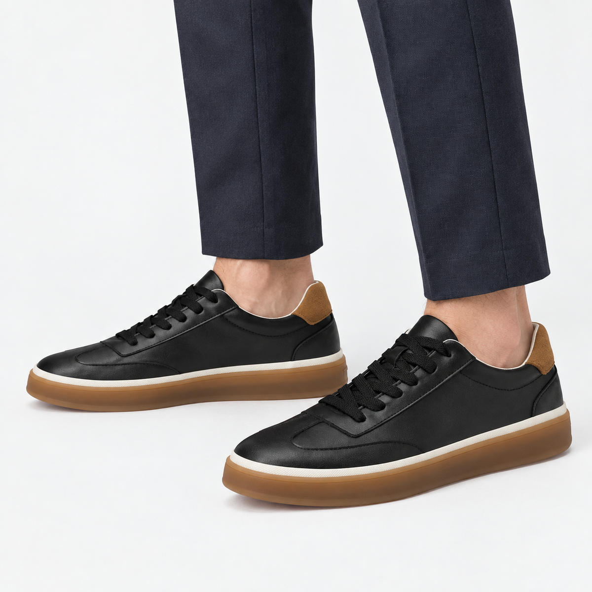 Leather court sneakers with gum soles in black, side view on a model