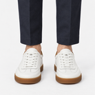 Leather court sneakers with gum soles in white, front view on a model