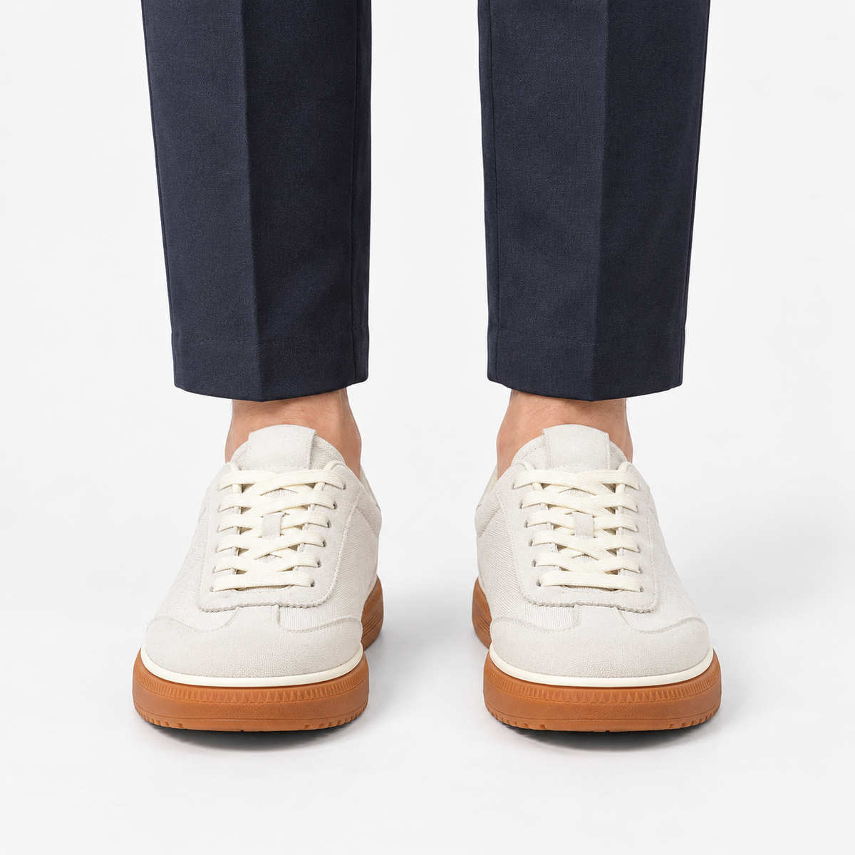 Leather low top sneakers with chunky gum soles in white, front view on a model