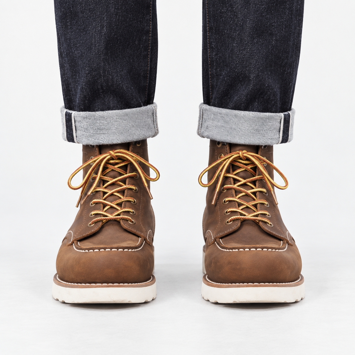 Leather moc toe wedge sole boots in brown, front view on a model
