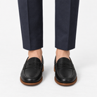Leather penny loafers with contrast soles in black leather, front view on a model