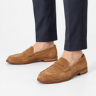 Leather penny loafers with contrast soles in tan suede, side view on a model