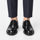 Leather plain toe derby shoes in black, front view on a model
