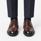 Leather plain toe derby shoes in brown, front view on a model