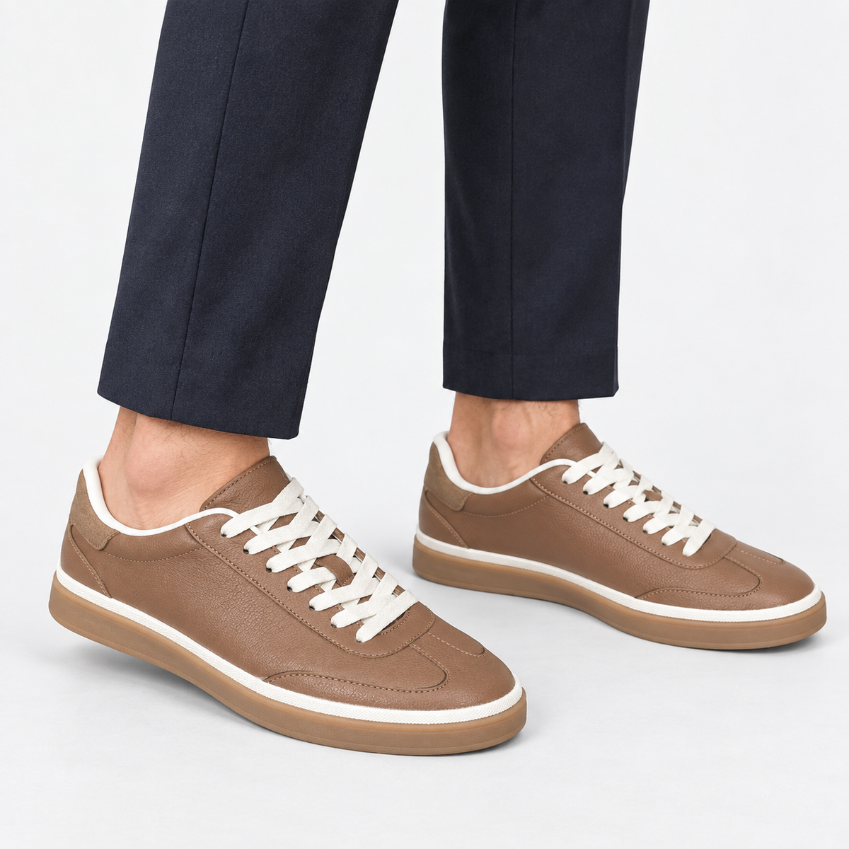 Retro leather sneakers with contrast soles in brown white sole, side view on a model