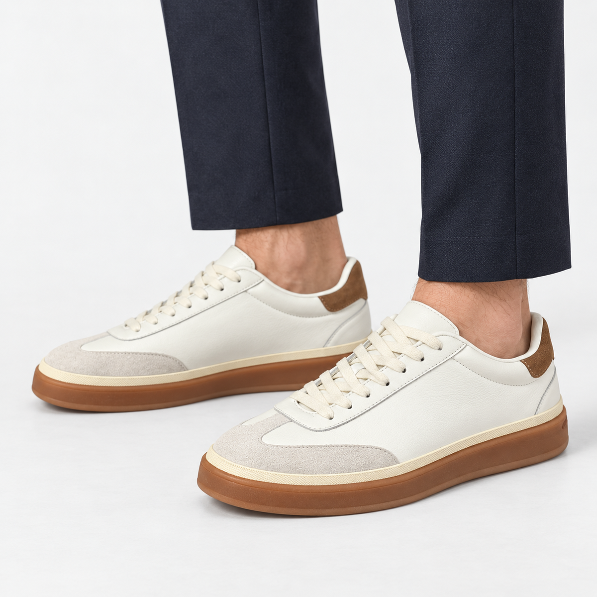 Retro leather sneakers with contrast soles in white gum sole, side view on a model