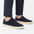 Retro low top sneakers with contrast soles in navy, side view on a model