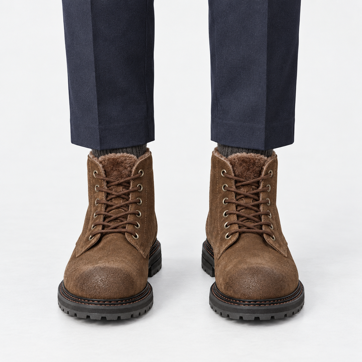 Rough suede lace up ankle boots in brown fleece lined, front view on a model