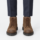 Rough suede lace up ankle boots in brown fleece lined, front view on a model