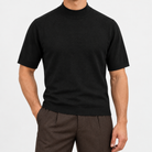 Short sleeve wool mock neck top in black, front view on a model