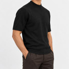 Short sleeve wool mock neck top in black, side view on a model